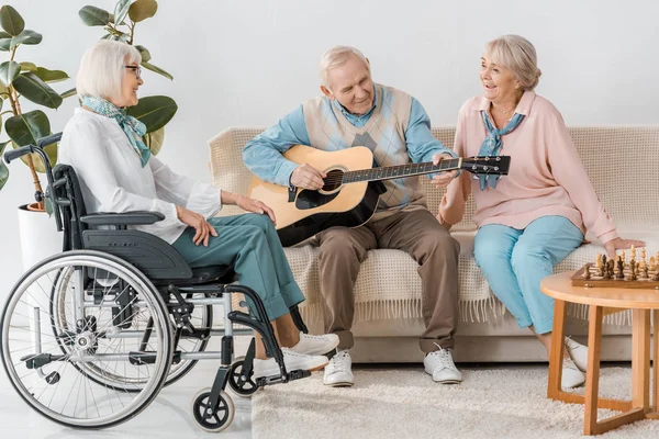 depositphotos_223169432-stock-photo-senior-man-sitting-sofa-playing